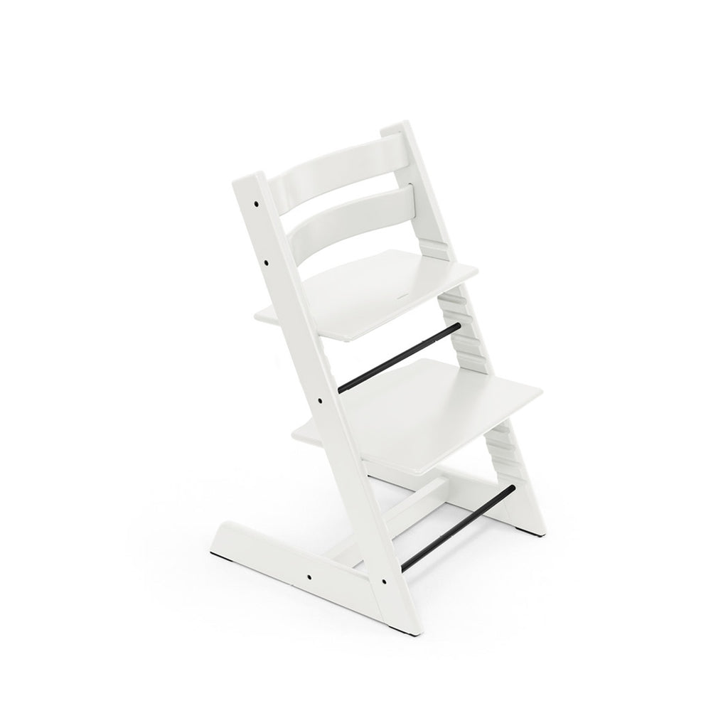 White adjustable wooden high chair with black footrest on white background. 
