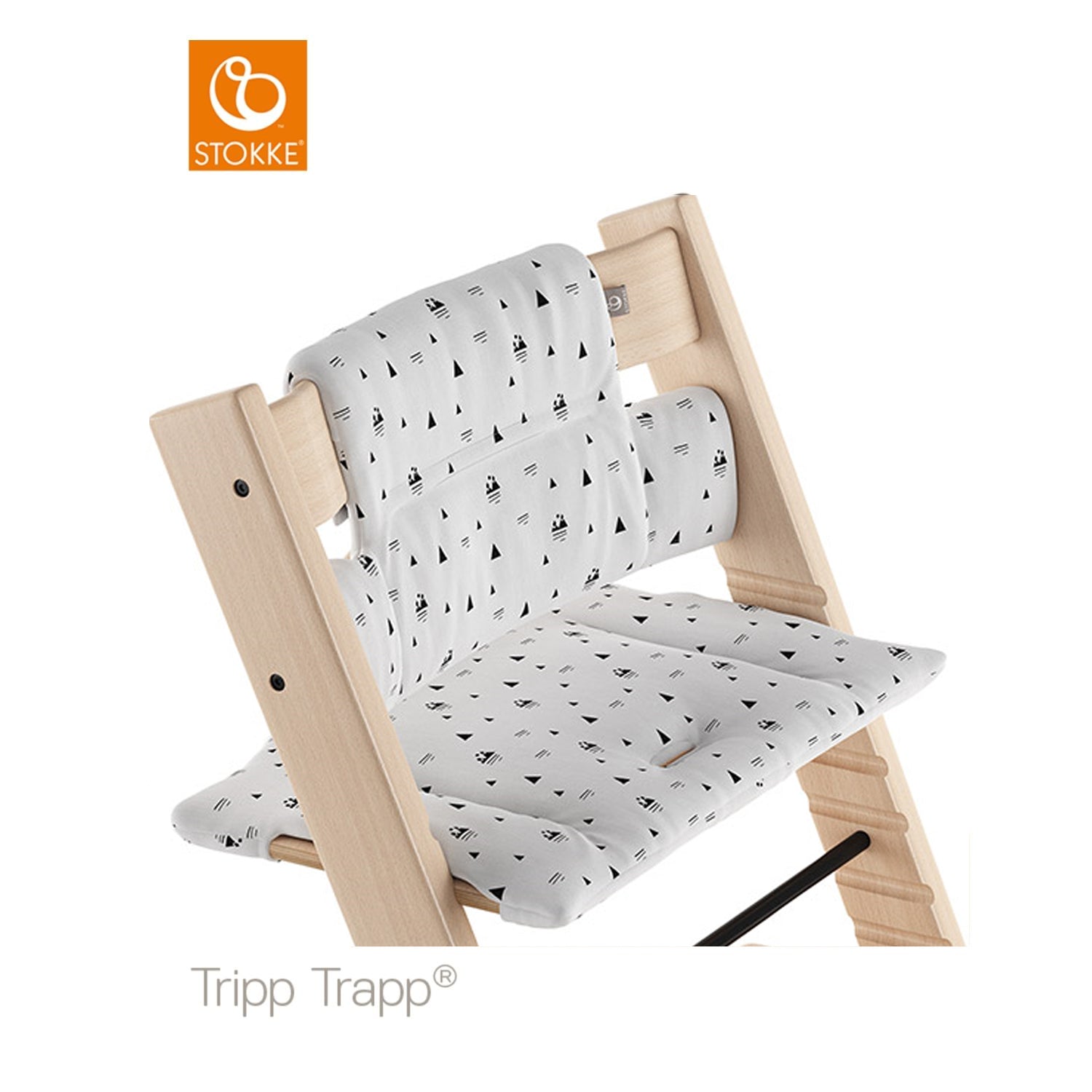 Stokke Tripp Trapp high chair featuring a white and black geometric patterned seat cushion and back support. 
